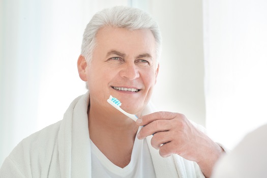Senior-Man-Brushing-his-Teeth
